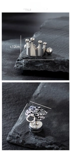 Detailed size display of crown and lion head stainless steel stud earrings on rock