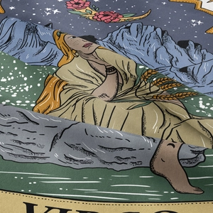 Detail of Virgo zodiac tapestry fabric with retro celestial art and textured material