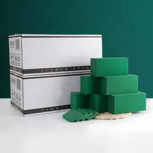 Close-up of premium green flower foam blocks in white cardboard packaging for floristry