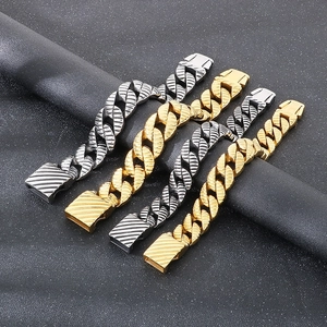 Detailed view of gold and silver thick Cuban bracelets with diagonal textured engravings