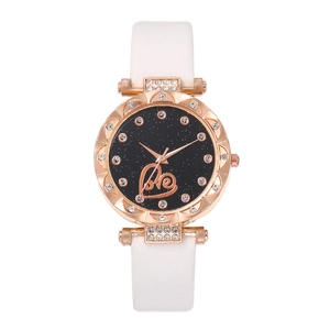 Detail of rose gold quartz watch with starry dial, crystal bezel and white leather strap