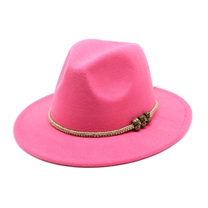 Macro detail of hot pink wool fedora hat with woven rope and vintage gold beads decoration