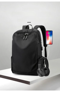 Detail view of the external USB charging port on a sleek black business laptop backpack
