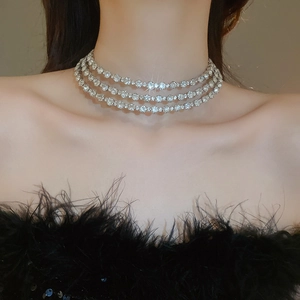 Close-up of a sparkling silver multi-layer rhinestone choker on a model's neck
