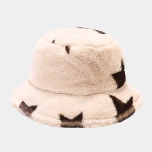 Close-up of thick plush faux fur bucket hat with brown star patterns for winter