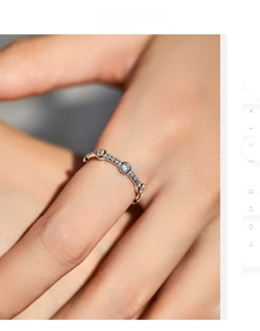 Macro shot of minimalist S925 silver ring with sparkling round cubic zirconia stones