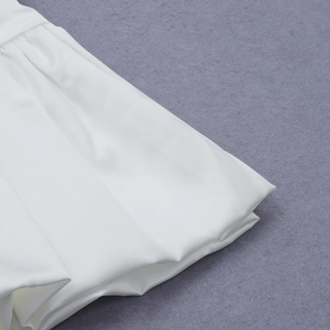 Macro shot of the intricate pleated waist detail on this elegant white two-piece dress set
