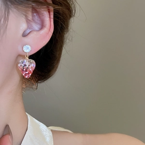 Close-up of strawberry drop earrings with glitter resin and sparkling zircon studs