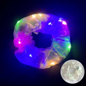 Detail of LED glowing organza hair scrunchie showing colorful light effect and texture