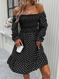 Detail of off-the-shoulder polka dot dress featuring elastic shirring and ruffled hem