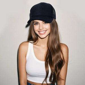 Front view of model wearing a breathable black trucker baseball cap with mesh back panels
