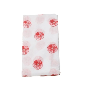 Detail showing the lightweight white fabric with vibrant red floral print on the scarf