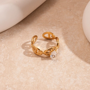 Detail of gold-plated pig nose anchor chain ring featuring an oval cubic zirconia stone