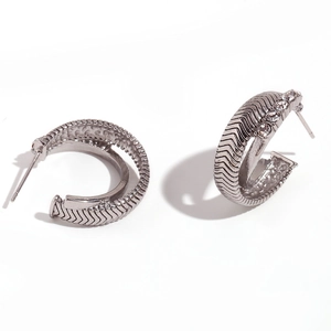 Polished silver-tone C-shape hoop earrings with chevron patterns and zircon inlay