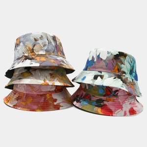 Stack of trendy double-sided floral bucket hats with artistic oil painting patterns