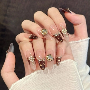 Luxury long almond press-on nails with brown gradient, champagne rhinestones and gold accents