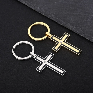 Detailed view of stainless steel cross keychains in gold and silver with screw accents