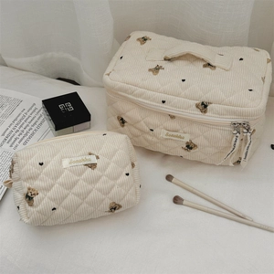 Quilted corduroy makeup bag set with cute bear patterns on a soft fabric background