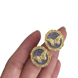 Vintage gold butterfly stud earrings with purple marble texture and intricate relief work