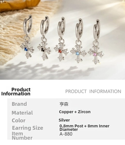 Detailed view of silver-plated copper hoop earrings with zircon-inlaid cross pendants