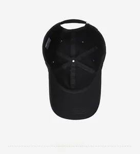 Internal view of a black cotton baseball cap showing 6-panel stitching and care label