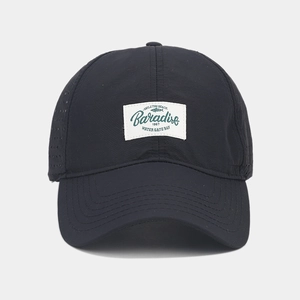 Detail of black quick-dry baseball cap with vintage Paradise embroidered patch and air vents
