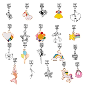 Macro shot of 20 colorful enamel charms including unicorn, crown and heart shapes