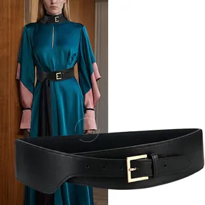 Women's black elastic waist belt with a golden square buckle for stylish dresses