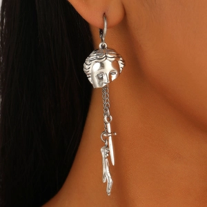 Gothic silver medusa portrait earrings with dagger and leg charms on model