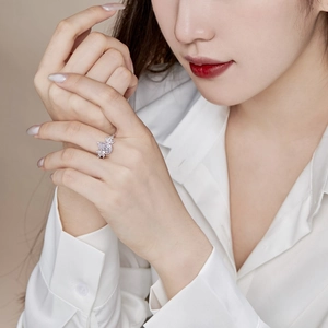 Close-up of S925 sterling silver ring with sparkling marquise zircon flower on finger