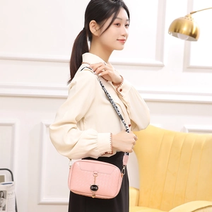 Pink shell crossbody bag with woven texture, cat pendant, and fashion wide strap