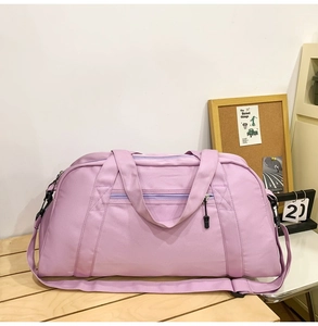 Large-capacity purple duffel bag for sports and travel, featuring durable handles and straps.