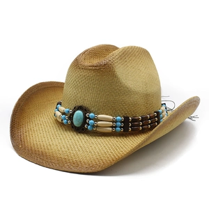 Western straw cowboy hat with ethnic beaded band and turquoise stone on white background