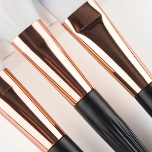 Set of shell-style makeup brushes with rose gold ferrules and soft white synthetic bristles