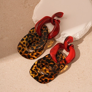 Exaggerated leopard print acrylic geometric interlocking earrings on a neutral stone base