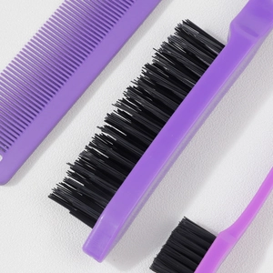 Close-up of professional purple hair styling brushes with dense black synthetic bristles