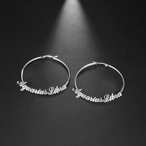 Silver stainless steel hoop earrings featuring Aquarius and Libra script lettering