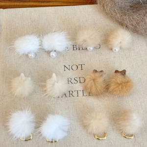 Winter collection of plush fur ball earrings with pearls and gold metal accents