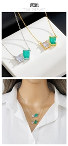 Detail view of gold and silver zircon pendant necklaces shown on stand and model