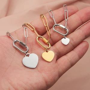 Three paperclip chain necklaces with heart pendants in gold and silver finish