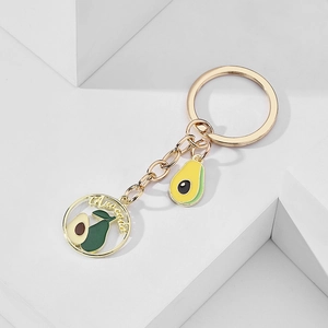 Detailed macro view of enamel avocado keychain with metallic finish and cutout charm