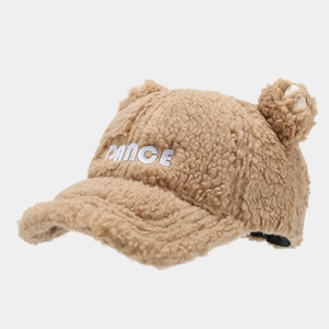 Detailed close-up of fluffy caramel bear ear baseball cap with white DANCE embroidery