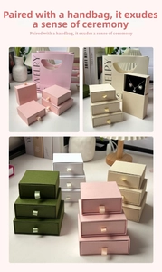 Detail of drawer-style jewelry gift boxes with ribbon handles and matching paper bags