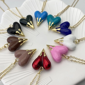 Macro shot of colorful heart pendants in ten shades with elegant golden claw settings