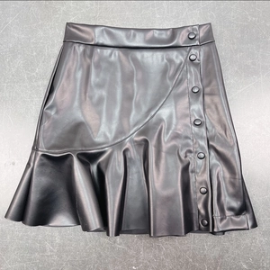 Detailed view of black PU leather mini skirt featuring decorative buttons and ruffled hemline