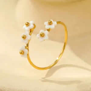 Detailed view of 18K gold titanium steel ring with white flower petals and zircon insets