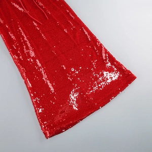 Close-up of shimmering red sequin fabric texture on this backless evening dress