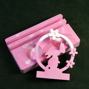 Detailed view of handmade pink marble resin candle holder with floral rabbit ring design