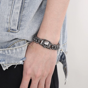 Close-up of retro punk skull chain bracelet in vintage silver finish on a male wrist