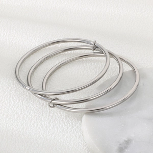 Detailed top view of a 3-piece silver stainless steel interlocking stackable bangles set
